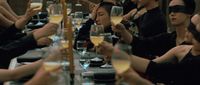 a group of people sitting at a long table