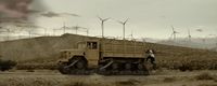 a large truck driving down a dirt road