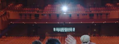 a group of people standing in front of a stage