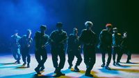 a group of young men standing on top of a stage