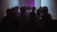 a group of people standing in a dark room