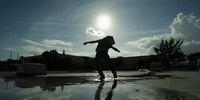 a person on a skateboard on a wet surface