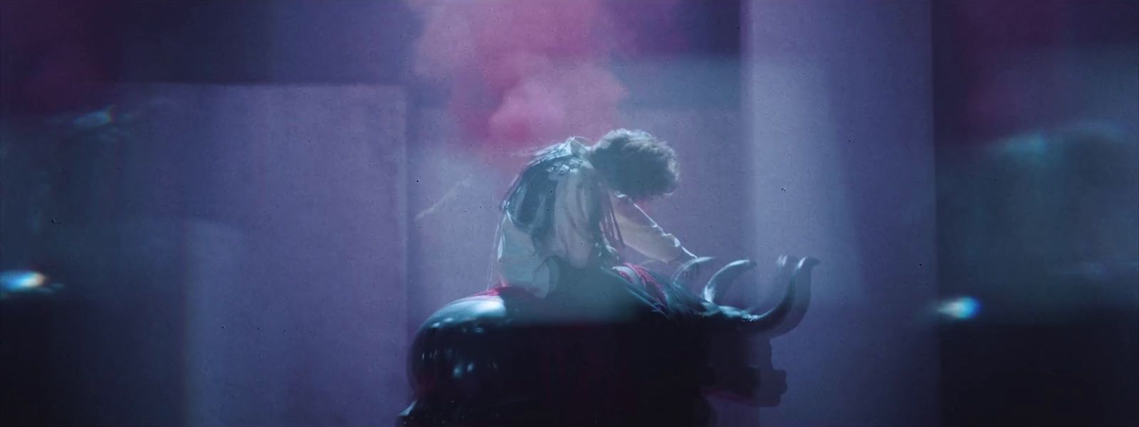 a woman smoking a cigarette in a dark room