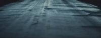 a person riding a skateboard down a snow covered road