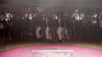 a group of people standing on top of a basketball court