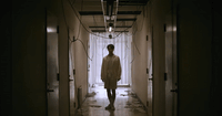 a person walking down a hallway in a building