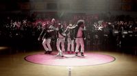 a group of people standing on top of a basketball court