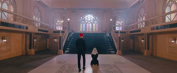 a man and a woman standing in a large building