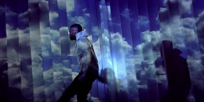 a man standing in front of a blue curtain