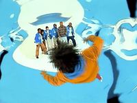 a group of people standing on top of a snow covered ground