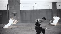 a black and white photo of a man throwing a ball