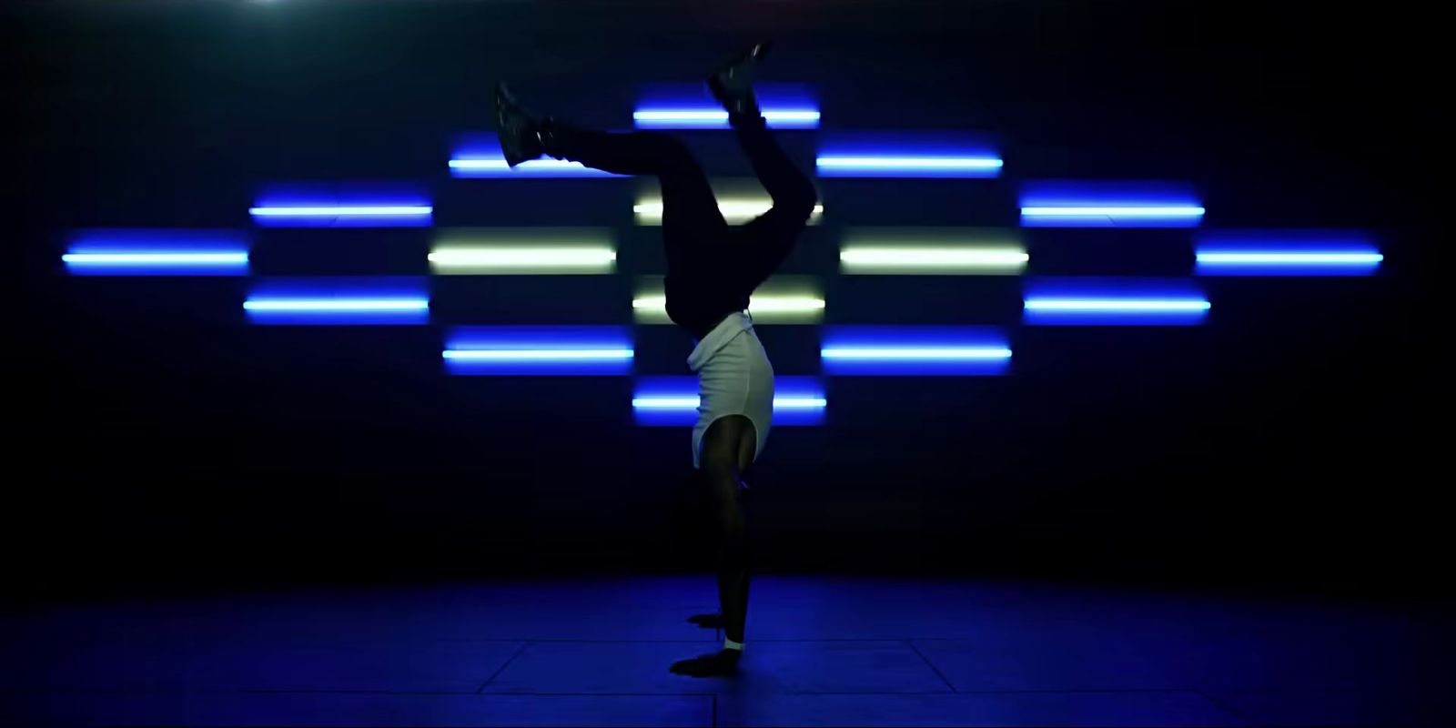 a person doing a handstand in a dark room