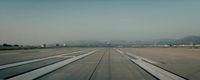 an airport tarmac with several planes parked on it