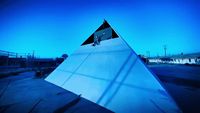 a large triangular object sitting in the middle of a parking lot