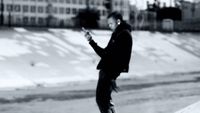 a man riding a skateboard down a street