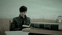 a man sitting at a table with two books