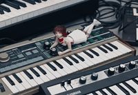 a doll laying on top of a keyboard