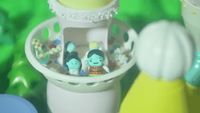 a group of small figurines sitting inside of a container