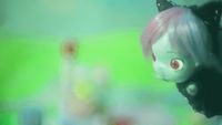 a close up of a cat doll with pink hair