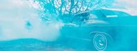 a blue car with smoke coming out of it