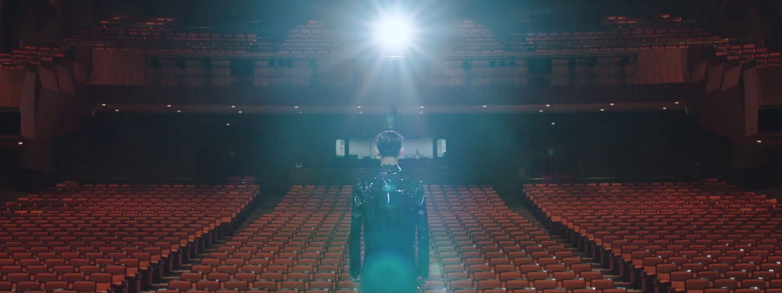 a person standing in front of an empty auditorium