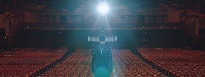 a person standing in front of an empty auditorium