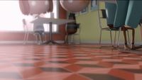 a room with a checkered floor and chairs