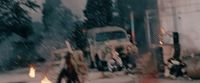 a group of people walking down a street next to a fire hydrant