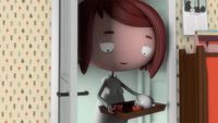 a little girl with red hair standing in a doorway