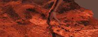 a woman standing on top of a red rock