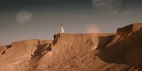 a man standing on top of a cliff