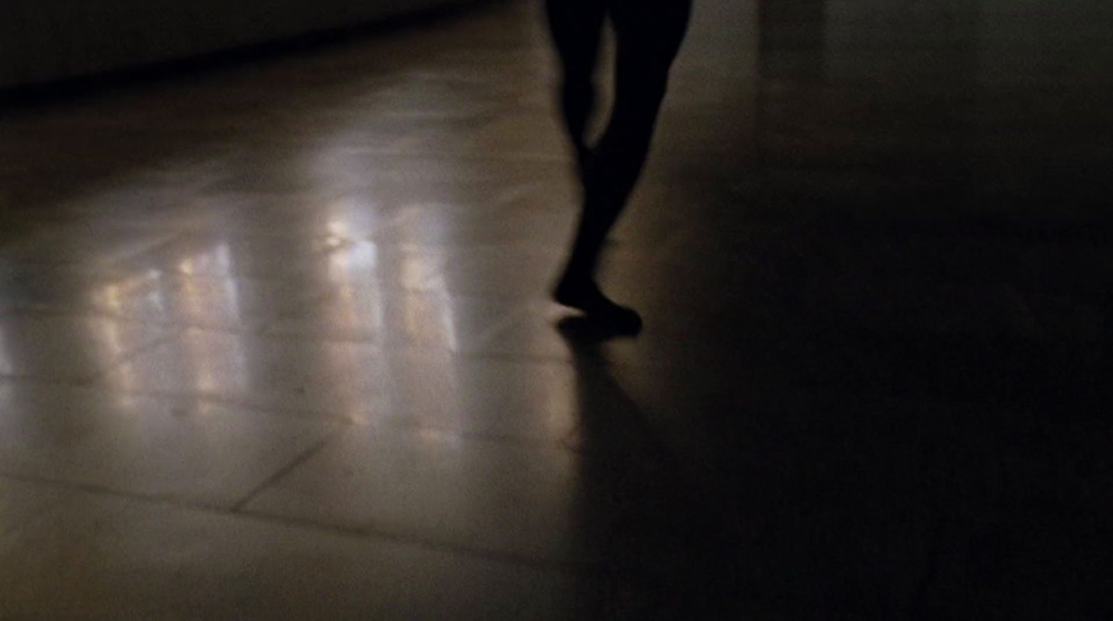 a person is walking in a dark room