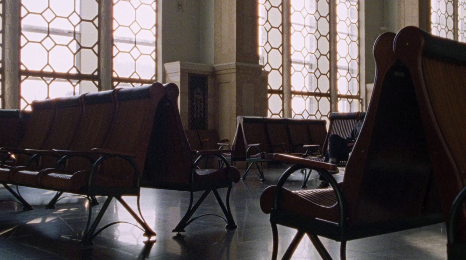 a row of wooden chairs sitting next to each other