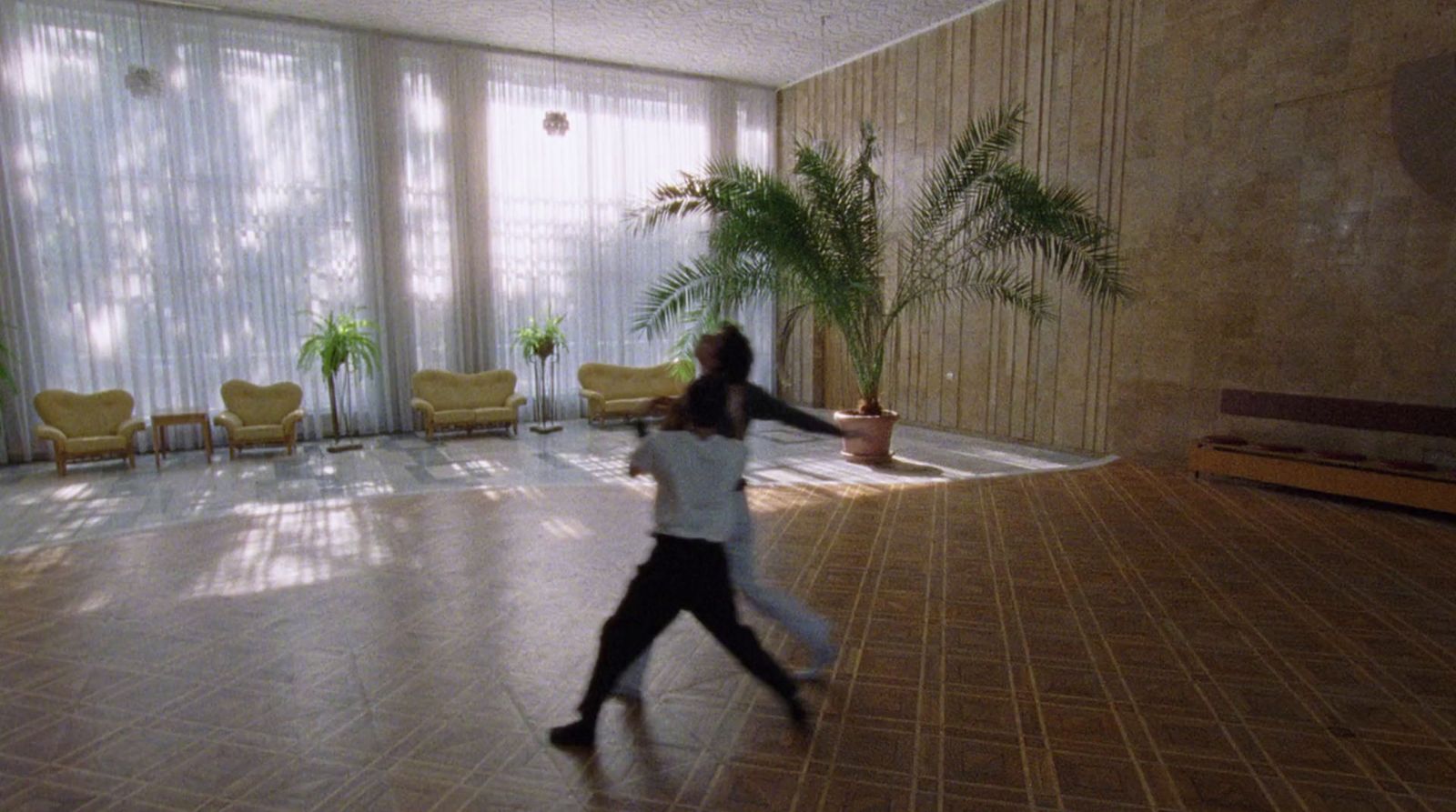 a woman is dancing in a large room