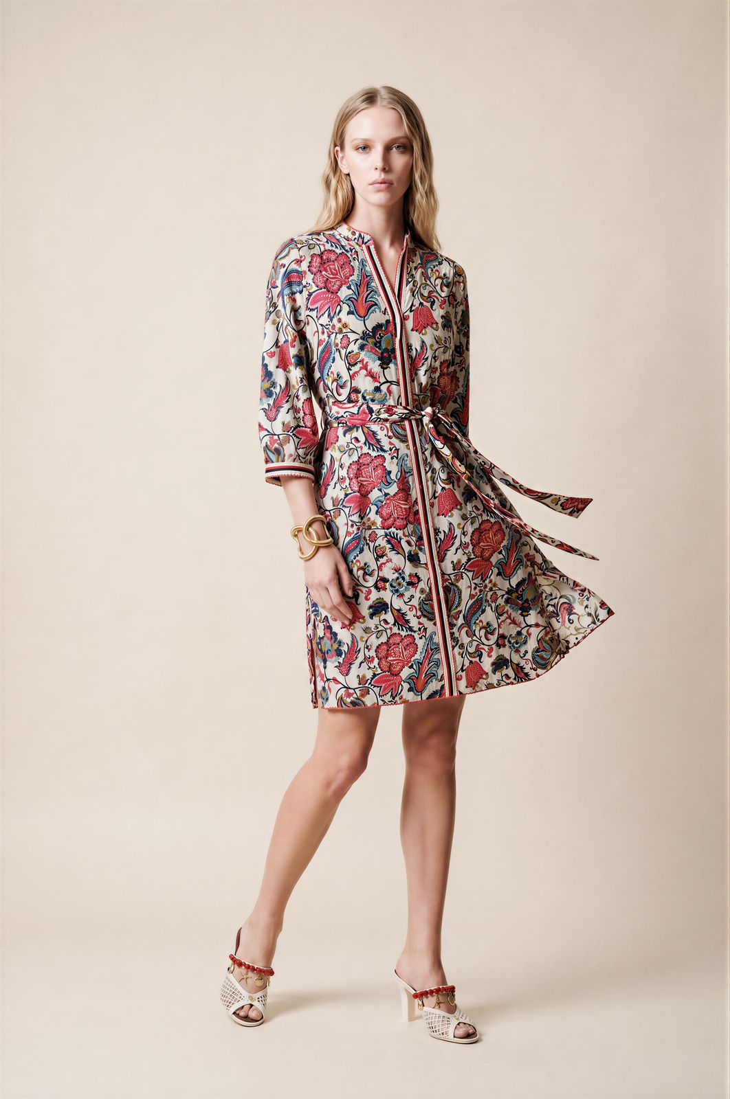 a woman in a floral dress poses for a picture