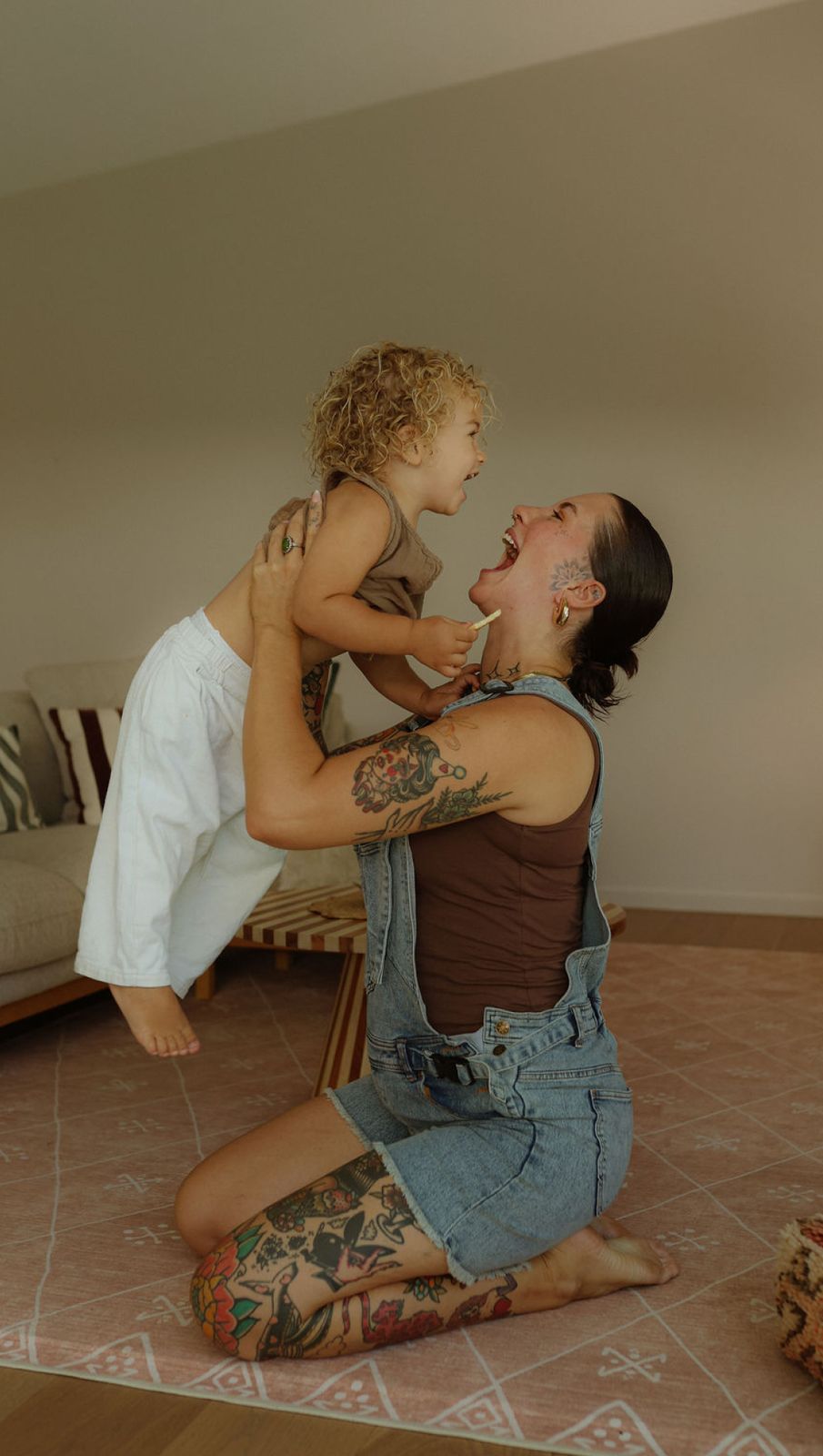 a woman holding a small child on her back