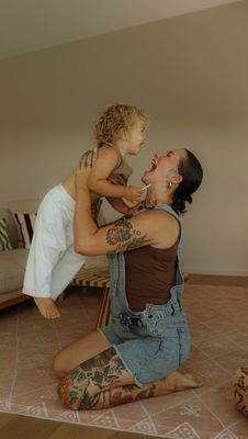 a woman holding a small child on her back