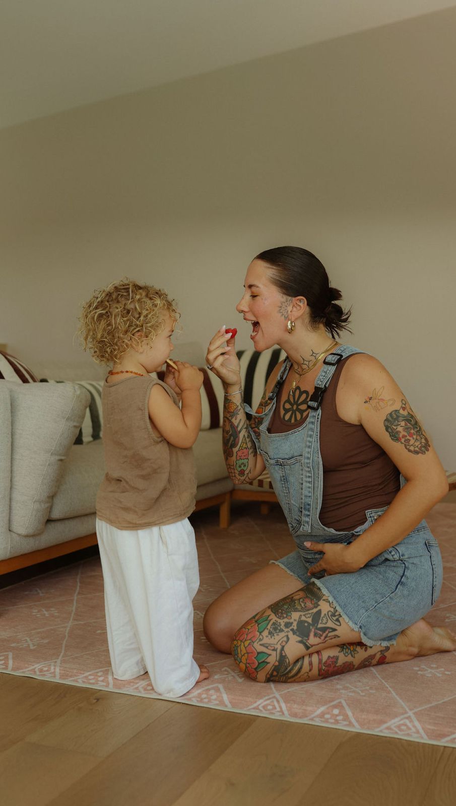 a woman and a child sitting on the floor