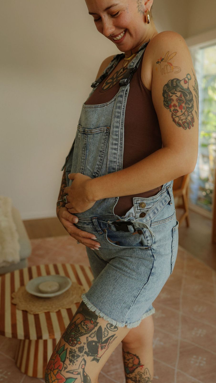 a woman with tattoos on her arms and legs