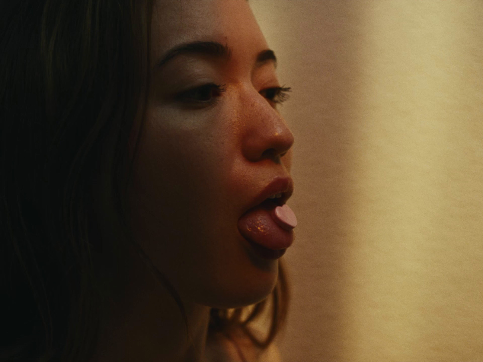 a woman sticking her tongue out in front of a mirror