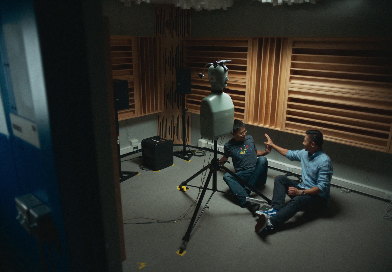 a couple of men sitting next to each other in a room