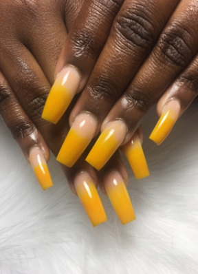 a woman's hands with yellow nail polish