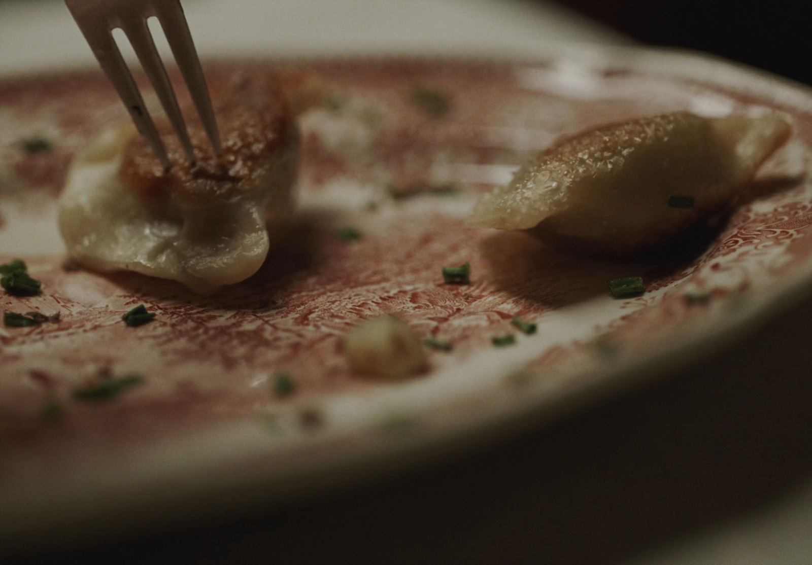 a fork sticking into a plate with food on it