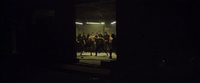 a group of people standing in a dark room