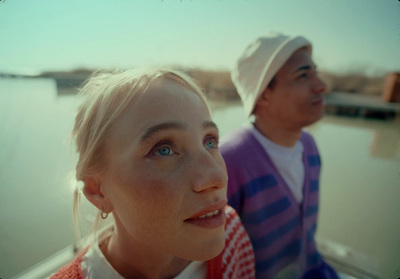 a man and a woman sitting next to each other on a boat