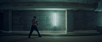 a man is walking in a dimly lit room