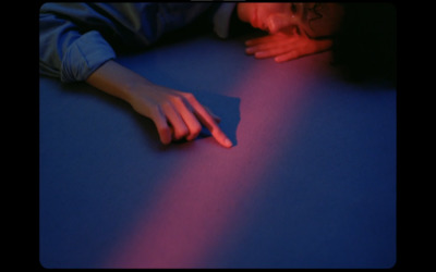 a person laying on a blue surface with their hand on a mouse pad