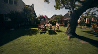 a couple of people sitting at a table in the grass