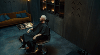 a man sitting in a chair in a room