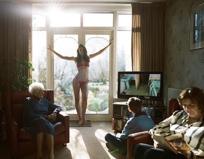 a woman in a bikini standing in a living room